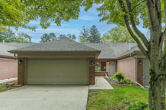 ranch-style home with brick siding, a shingled roof, a garage, and concrete driveway