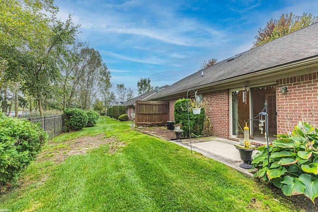 view of yard featuring fence and a patio area
