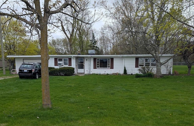 single story home featuring a chimney, an attached garage, and a front yard