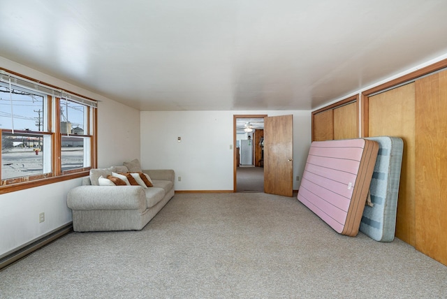 carpeted living room with baseboards
