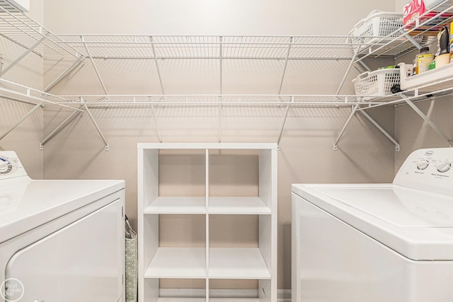 washroom with washing machine and clothes dryer and laundry area