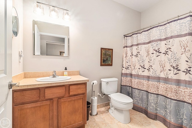 bathroom with vanity, tile patterned flooring, toilet, and curtained shower