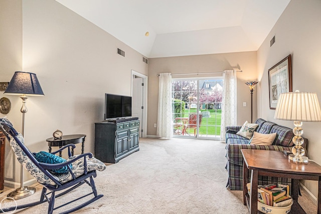 living area with carpet floors, high vaulted ceiling, and visible vents