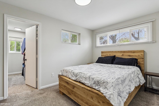 carpeted bedroom featuring baseboards