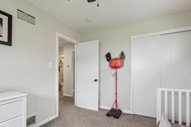 unfurnished bedroom with a closet, carpet flooring, and visible vents
