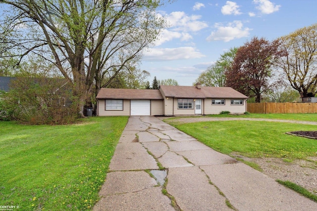 ranch-style home with fence, an attached garage, a front lawn, and aphalt driveway
