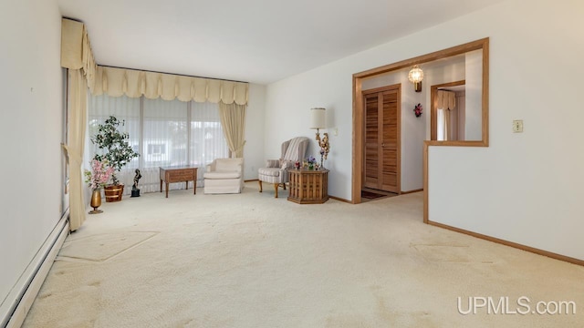 sitting room featuring carpet floors and a baseboard heating unit