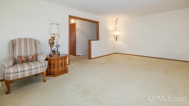 living area with baseboards, carpet flooring, and a baseboard radiator
