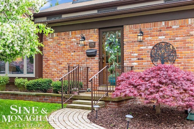property entrance featuring brick siding