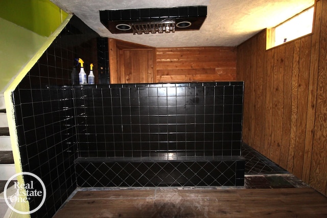bathroom featuring wooden walls