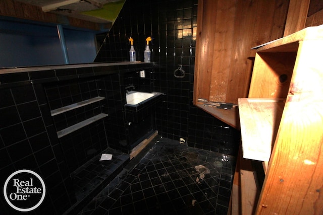 bathroom with a sink, tile patterned flooring, and walk in shower