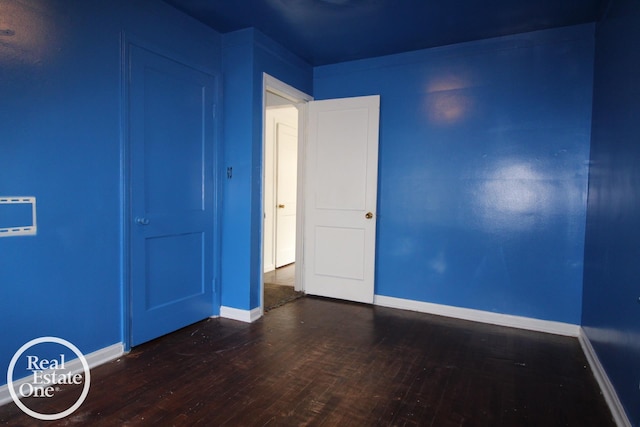 unfurnished bedroom featuring baseboards and wood finished floors