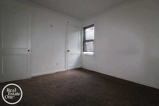 carpeted empty room with baseboards
