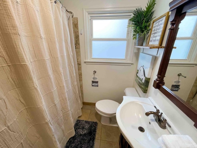 bathroom with tile patterned flooring, a sink, toilet, and a shower with curtain