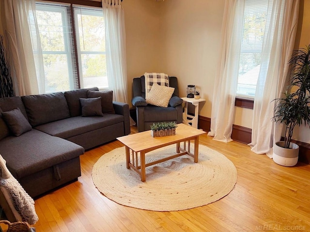 living area with plenty of natural light and light wood-style flooring