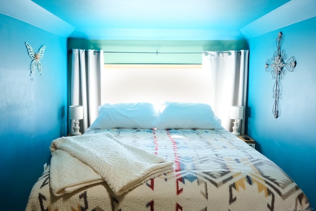 bedroom with multiple windows and vaulted ceiling