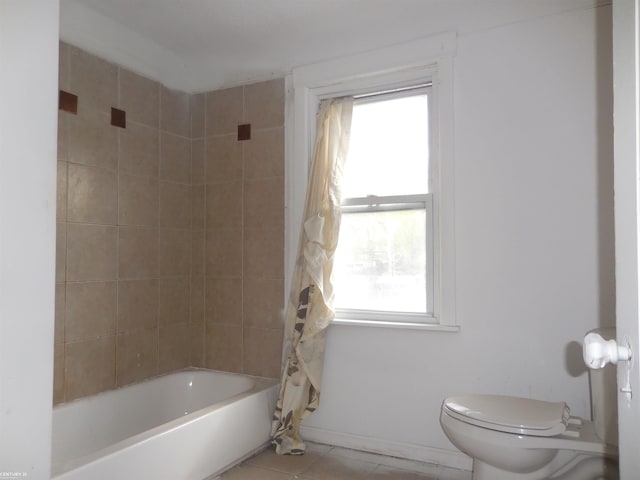 bathroom with shower / tub combo, tile patterned flooring, toilet, and a wealth of natural light