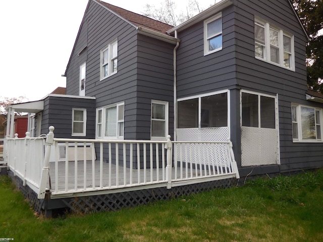 back of property featuring a wooden deck