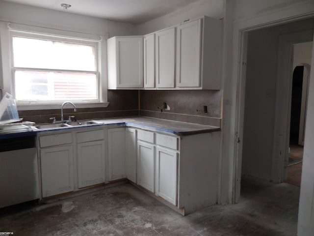 kitchen with white cabinetry, a sink, and dishwasher
