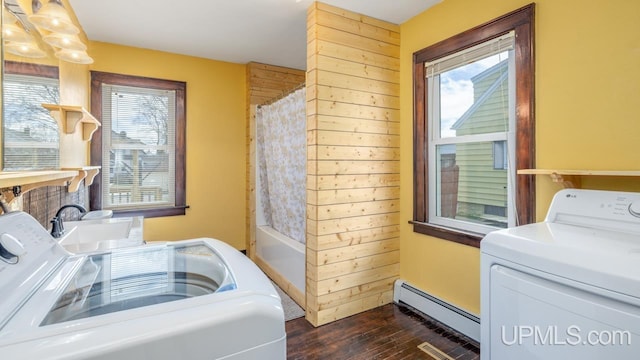 laundry area with laundry area, dark wood-style flooring, independent washer and dryer, a sink, and a baseboard radiator