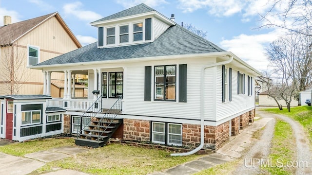 view of front of home featuring a porch and roof with shingles