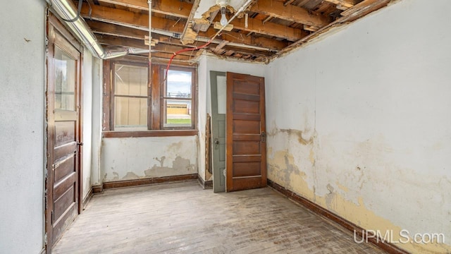 empty room featuring baseboards and wood finished floors