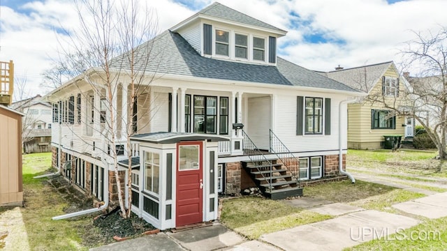 view of front of property with roof with shingles and covered porch