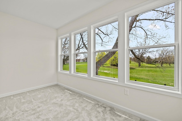 carpeted empty room with baseboards