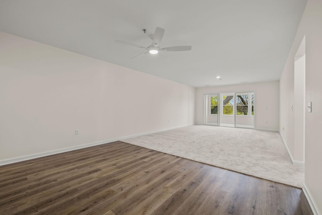 unfurnished room with baseboards, ceiling fan, and wood finished floors