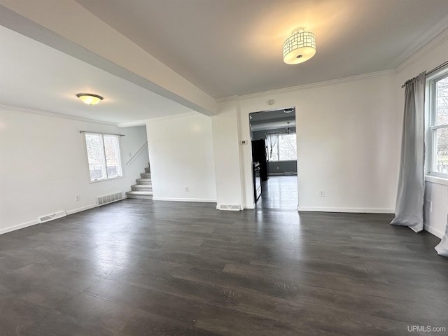 spare room with visible vents, crown molding, and a wealth of natural light