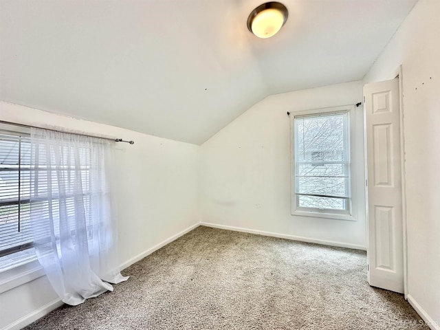 bonus room featuring carpet floors, baseboards, and vaulted ceiling