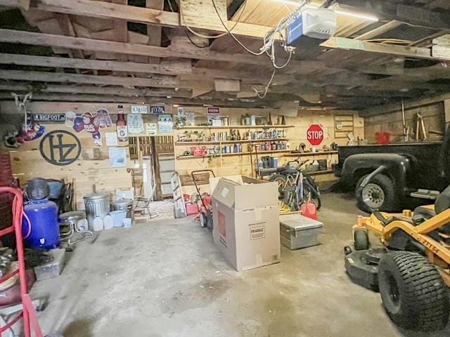garage with a workshop area and a garage door opener