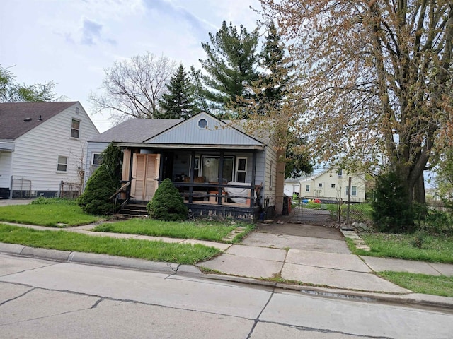 view of front of home with fence, a gate, and a porch