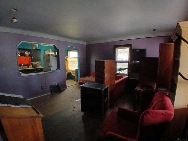 carpeted cinema room with arched walkways and a wealth of natural light