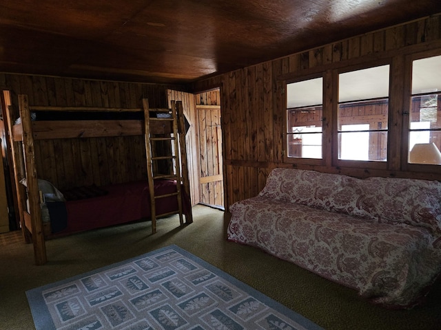 bedroom featuring carpet floors, wooden walls, and wood ceiling
