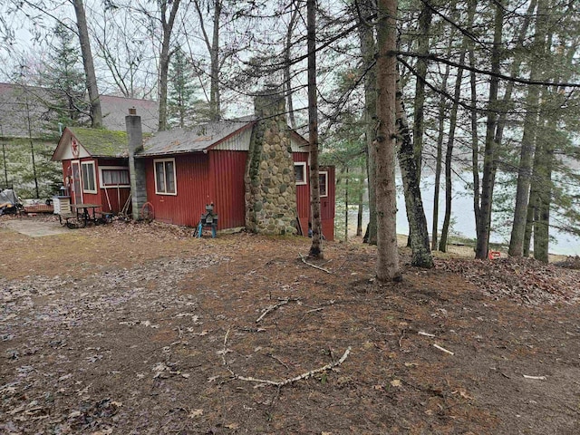 view of property exterior featuring a chimney