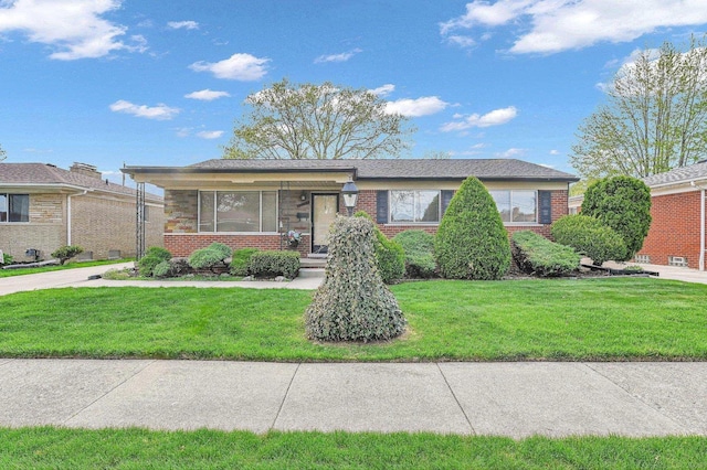 view of front of property with a front yard and brick siding