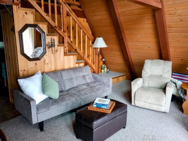 living room featuring wood walls, carpet, stairs, vaulted ceiling with beams, and wood ceiling
