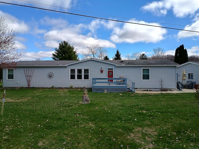 back of house featuring a yard and a deck