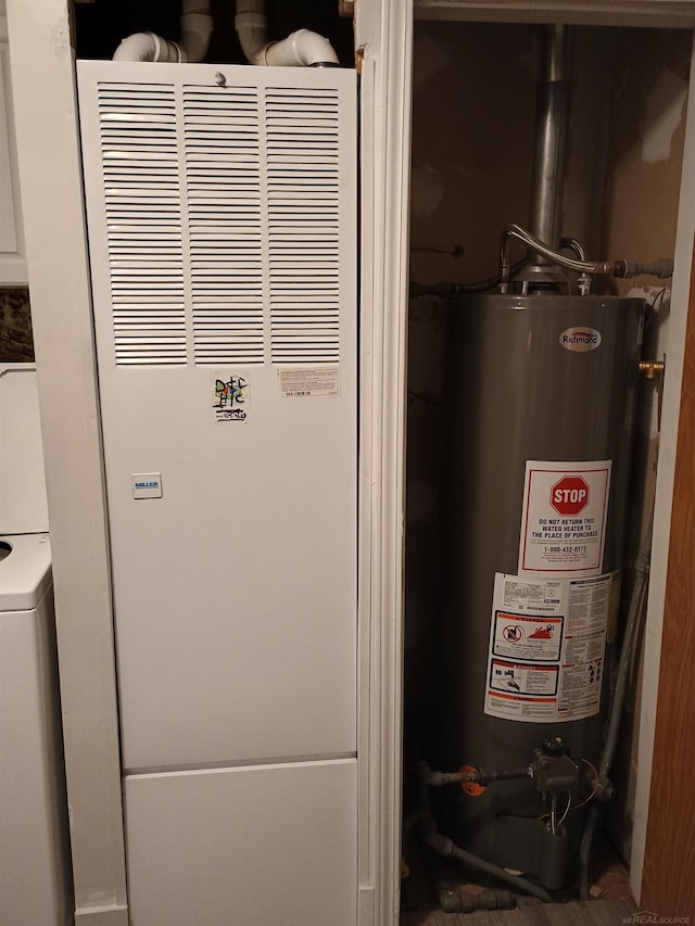 utilities with a heating unit, washer / dryer, and gas water heater