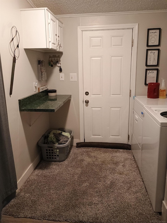 washroom featuring cabinet space, crown molding, separate washer and dryer, a textured ceiling, and carpet