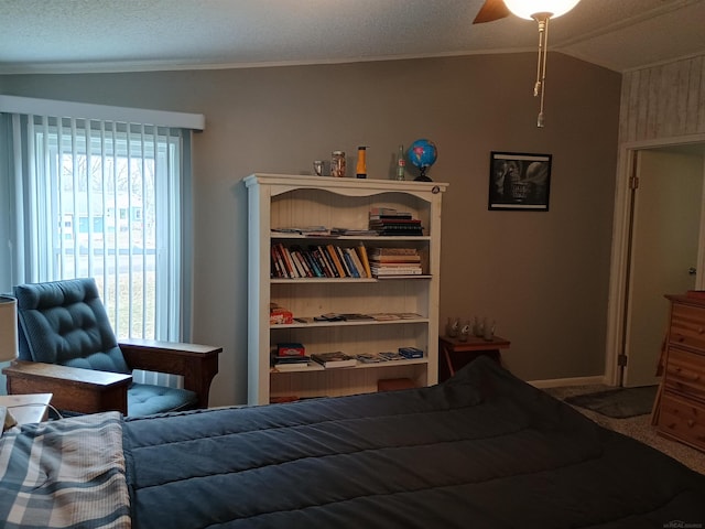 carpeted bedroom featuring ornamental molding, a textured ceiling, a ceiling fan, and lofted ceiling