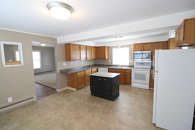 kitchen with baseboard heating, a sink, white appliances, a kitchen island, and a baseboard heating unit