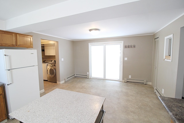 kitchen featuring freestanding refrigerator, a baseboard heating unit, brown cabinetry, and washing machine and clothes dryer