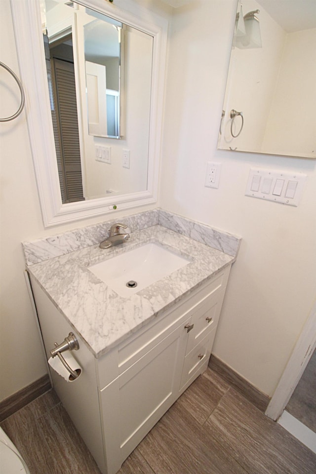 bathroom featuring vanity and wood finished floors
