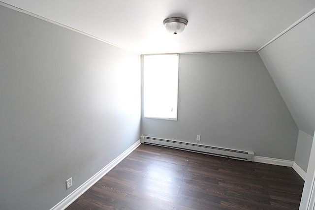additional living space featuring baseboards, a baseboard heating unit, dark wood-style floors, and lofted ceiling