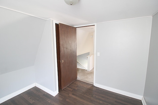 interior space with baseboards and dark wood-type flooring