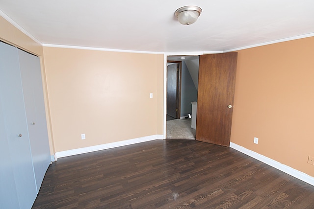 empty room featuring crown molding, baseboards, and dark wood-type flooring