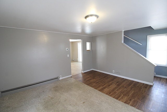 spare room with baseboards, a baseboard radiator, a baseboard heating unit, and a wealth of natural light
