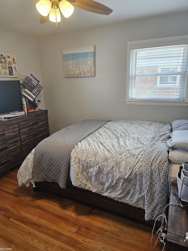 bedroom with a ceiling fan and wood finished floors